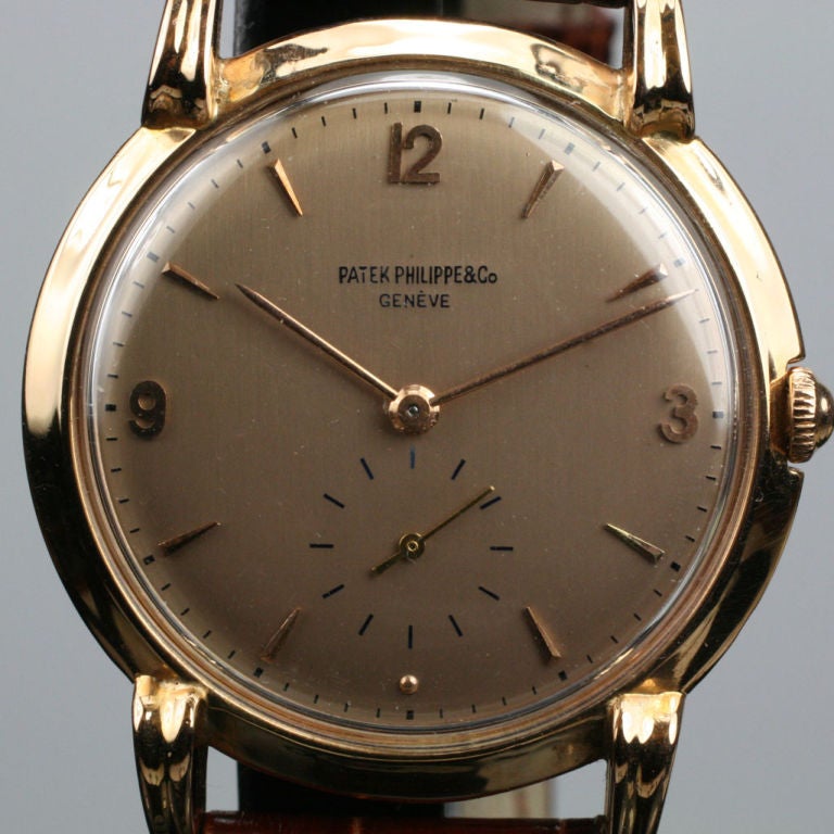 This is a beautiful vintage dress watch by Patek Philippe with nicely scrolled lugs and a rose colored dial.  It is a manual wind with an Extract from Patek's archives dating it to 1948.