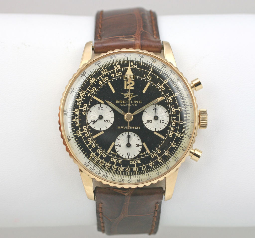 This is a Breitling Genève Navitimer reference #806, in 18k yellow gold. This watch features a three register chronograph with a manual wind movement. This watch is in beautiful condition with an original black dial, gilt writing, plastic crystal