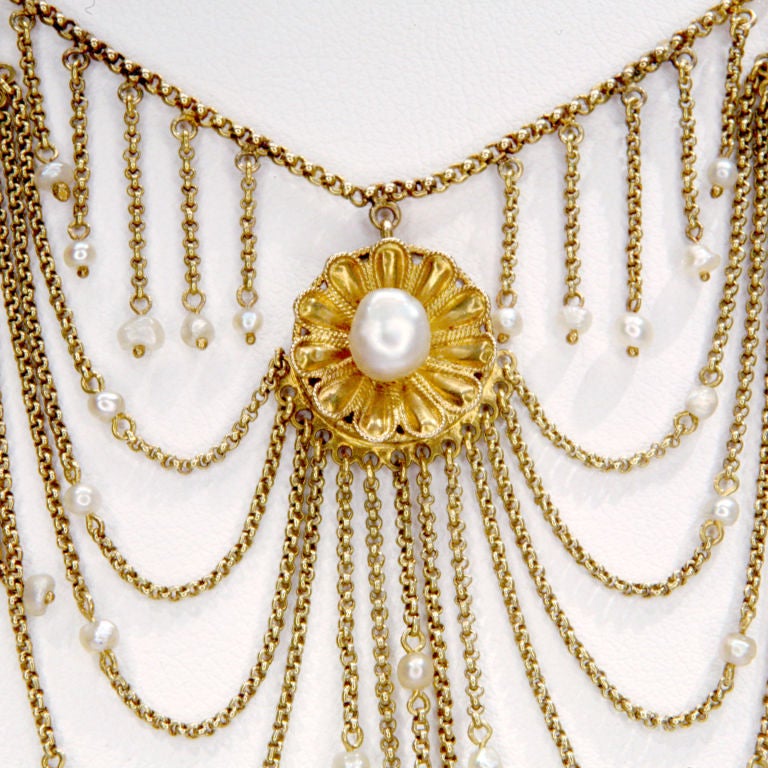 Delicately draped antique 18k gold chain collarette with seven medallions of seed pearls, and gold and seed pearl closure.  Tiny seed pearls dangle from all the chains.