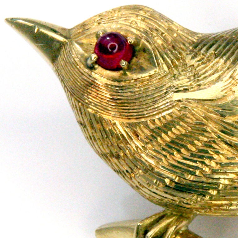 Charming baby chick gold brooch with ruby eye.  Perched on gold branch with diamond inset.  Realistic etching on body.  Signed 
