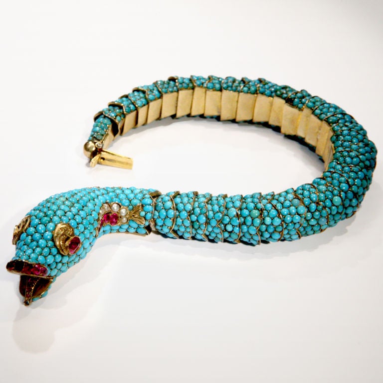 Fabulous turquoise and gold serpent bracelet with ruby eyes, mouth and tongue, and ruby and pearl embellishments.  Body is beautifully articulated and completely encrusted with hundreds of turquoise beads that form lifelike scales.