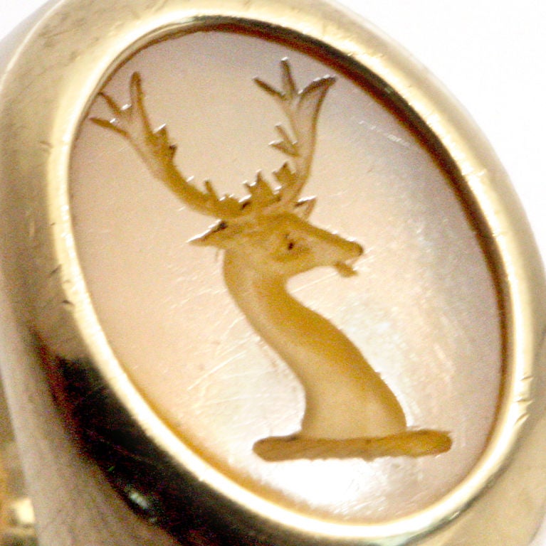 Unusual heavy 18 karat gold seal ring with antlered stag figure carved into chalcedony quartz.