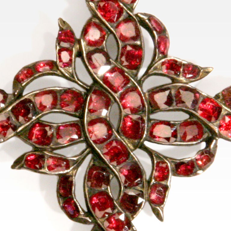 Striking ruby antique 9 karat gold cross pendant with braided swirls of rubies.  Bale for hanging.