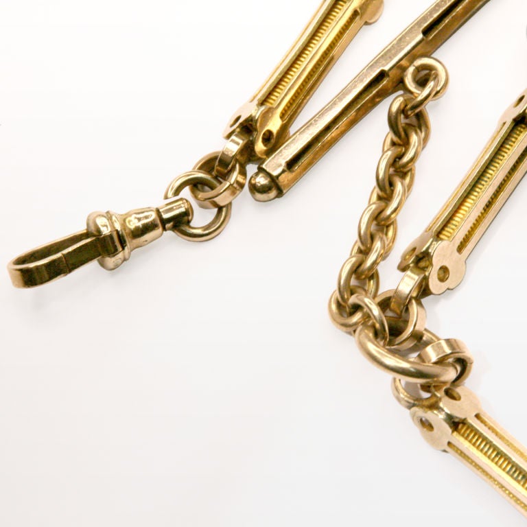 Antique 9 karat watch fob chain with attached t-bar and hanging fob.  Lightweight with elaborate detailing.