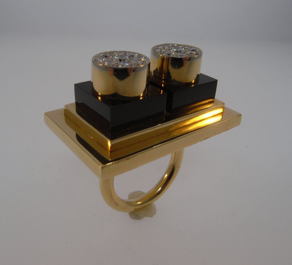 An 18kt gold, onyx and diamond ring designed by Ettore Sottsass (1917-2007).  Sottsass is best known as the founder of the Memphis Collective in the 1980s, and also for his work in glass and ceramics.  He designed iconic electrical products for