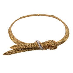 A gold and diamond strap necklace