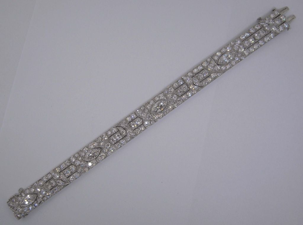 A fine Art Deco diamond bracelet by Marcus and Co., comprising four marquise diamonds weighing approximately 6 carats in total, and set with 168 brilliant cut diamonds weighing approximately 12 carats in total.  The diamonds are mounted to a