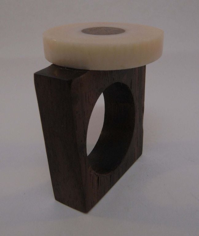A ring by Catherine Noll designed as a wooden square surmounted with an ivory and wood disc.  Ring size 11.5.  From an important private collection.  Catherine Noll was the grand-daughter of Alexandre Noll; the furniture designer and sculptor.