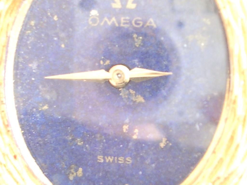 A stylish 18k yellow gold and lapis  bracelet watch by Roy King. King,known for his innovative use of gold and hardstone ( Like lapis, onyx, coral) helped to spark the designer watch movement by using materials in a new way - not only for watches