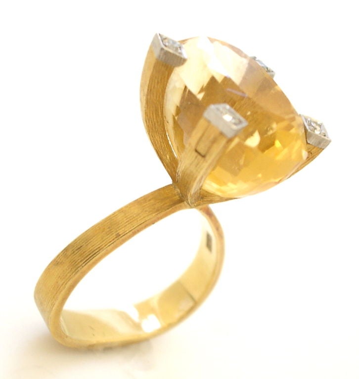 A stylish ring by Andrew Grima(1921-2007). The mixed-cut citrine weighing approximately 13.0cts (citrine just under 3/4
