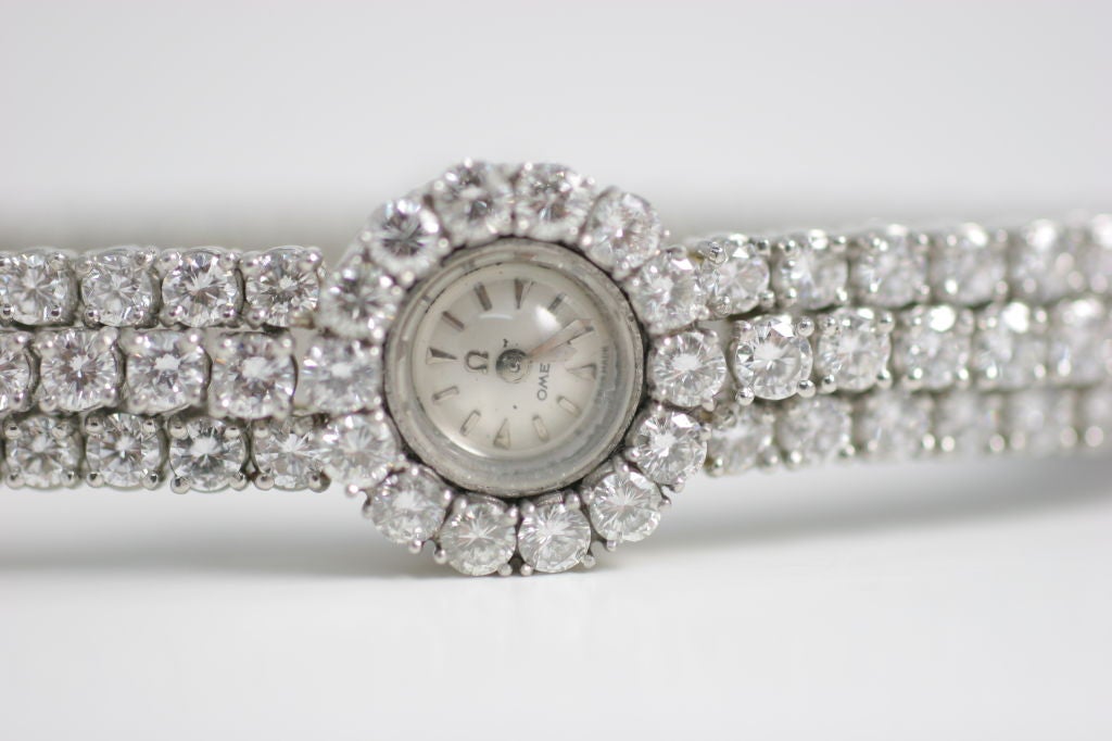 An exceptional 'Omega' watch with three rows of round diamonds and diamond bezel, weighing approxiately 15 carats.