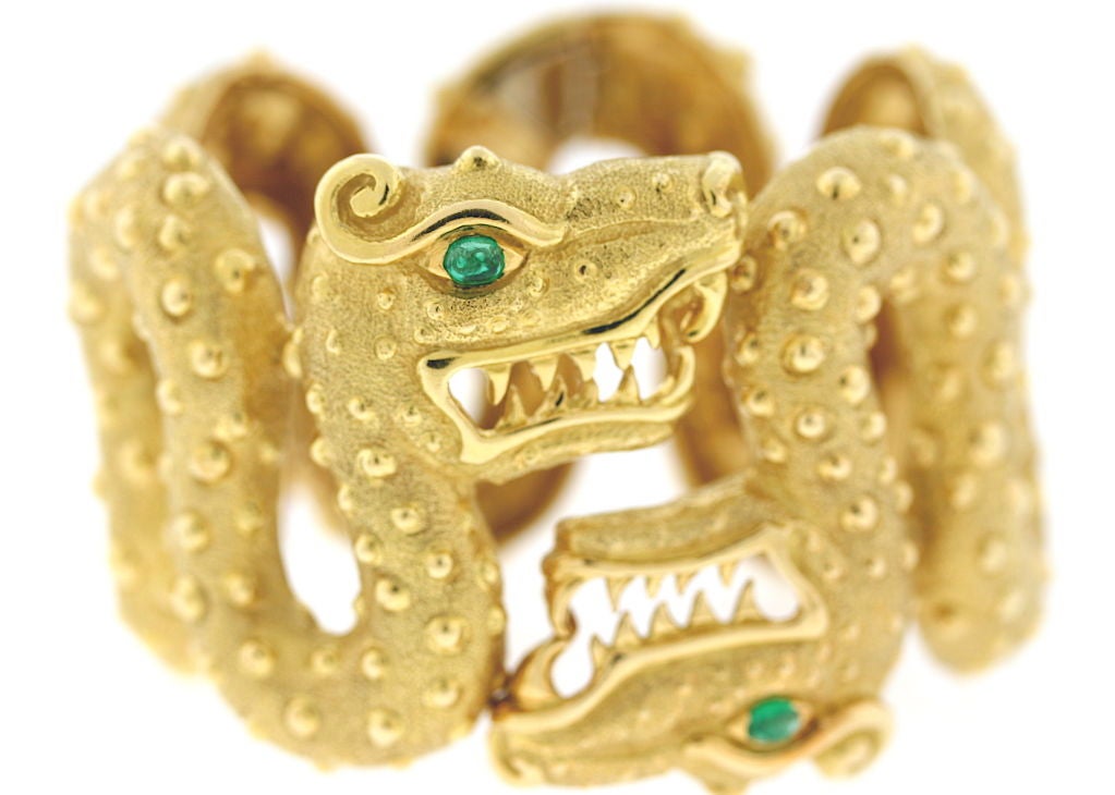 David Webb 18k gold wide double dragon head cuff hinged bracelet, cabochon emerald eyes, beautifully made and very comfortable on the wrist, 6.5