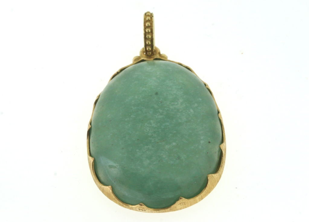 18k gold Sagittarius zodiac pendant mounted on light green stone, 1.75