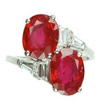 An oval-cut ruby two-stone cross over ring