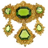 A peridot and gold corsage ornament
