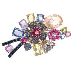 A multi-colored sapphire and diamond floral spray brooch