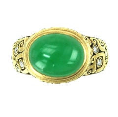 A cabochon jade and diamond ring A cabochon jade and diamond ring