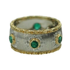 An emerald and gold band ring by Buccellati