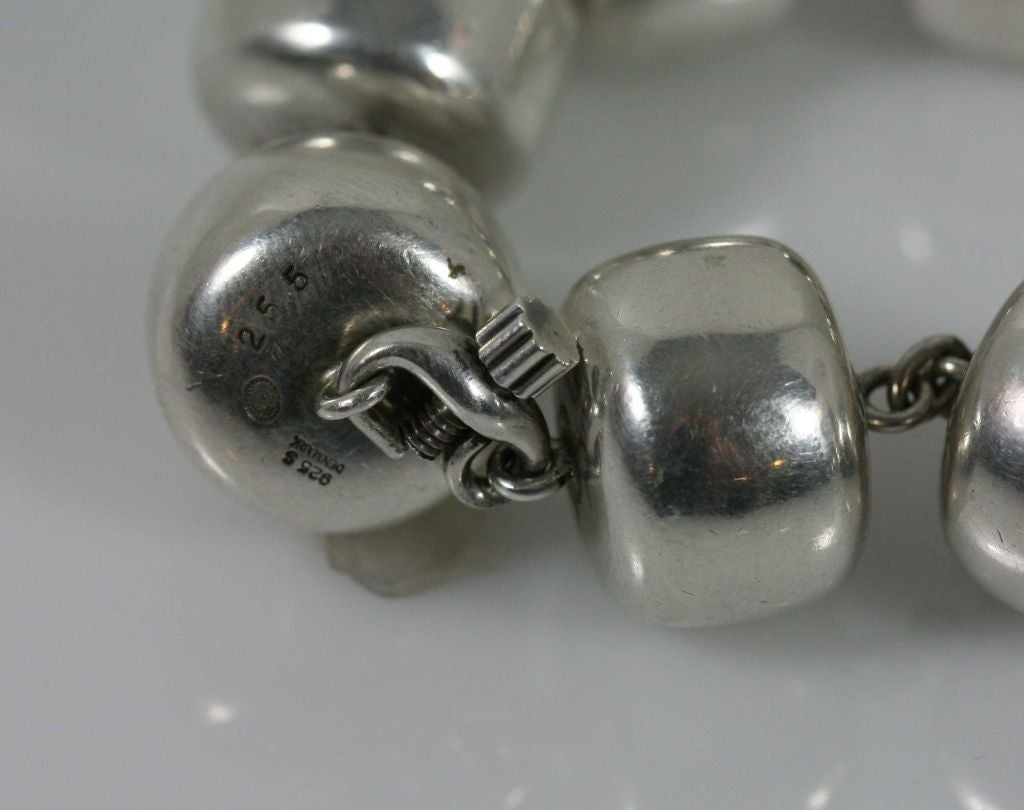 Georg Jensen sterling silver bead necklace #255 designed by Kim Naver. The necklace is composed of linked cyndrical-shaped beads terminated with a screw clasp. This necklace is circa 1971 and bears impressed company marks along with limited London