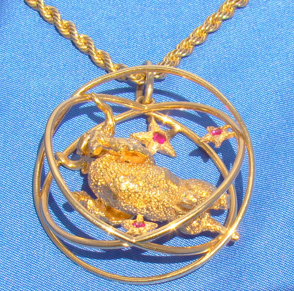 Signed by famous Hollywood designer William Ruser. 14K Yellow Gold Taurus with Ruby eyes. 5 rubies total.  18.25