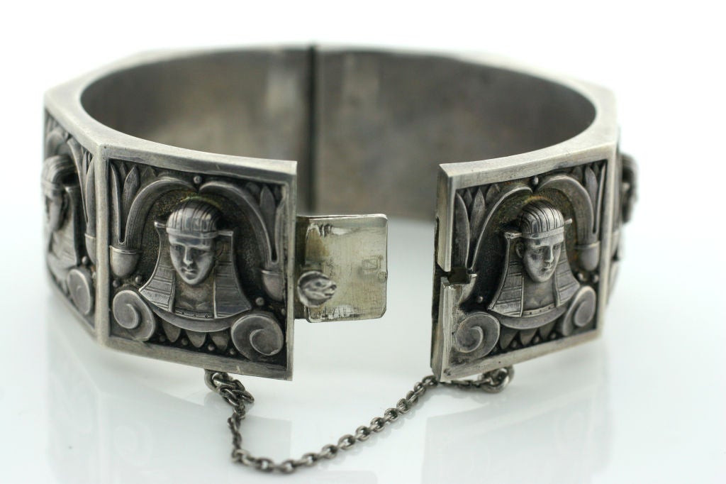 This is a Silver Bangle Bracelet done in the Egyptian Revival style. It is ornament is tribute to the Repoussé shaping process, producing the sphinx design of the bracelet. Made by Tepazio of the Iberian Peninsula, a renown Silver designer since