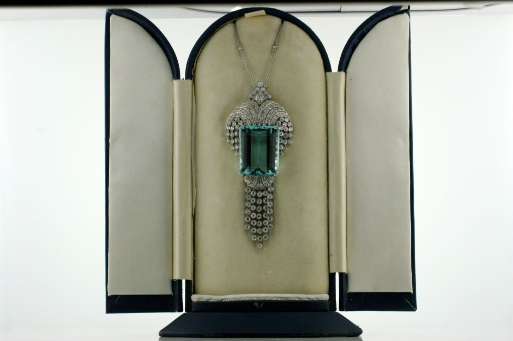 Platinum pendant with a large Emerald Cut Aquamarine, totaling 53.34 carats.   It also has very fine well matched diamonds, totaling 7.5 carats and a platinum chain interspersed with diamonds. Made in England, circa 1930's.