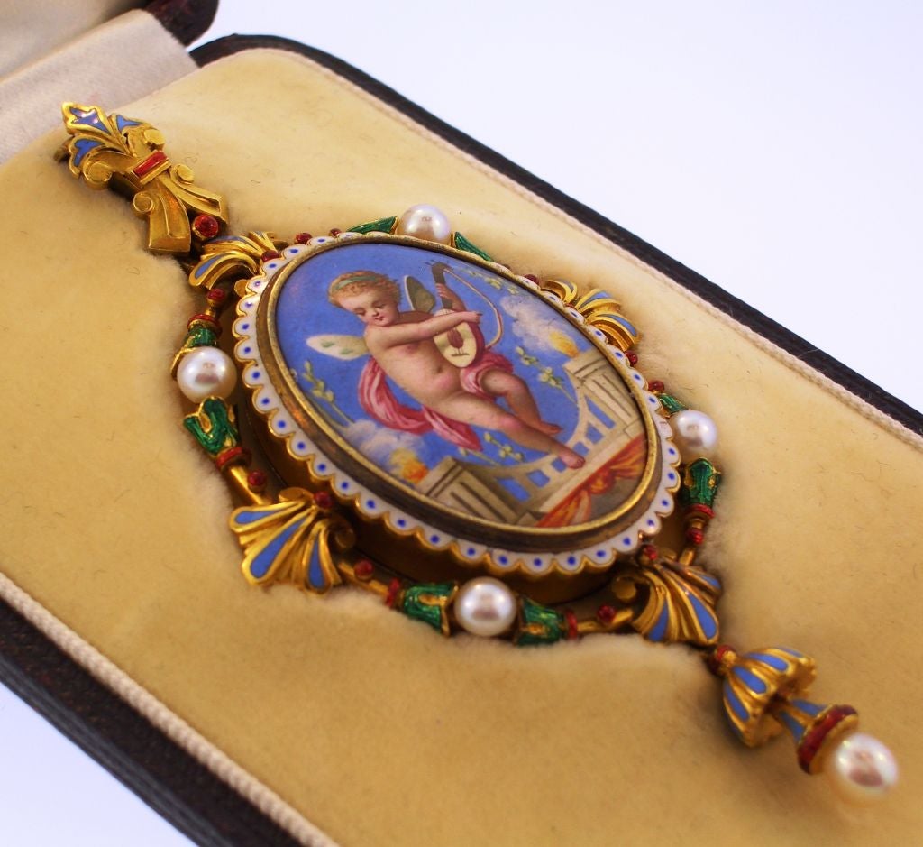 An ornately enameled 18K gold pendant set with pearls, in it's original box !