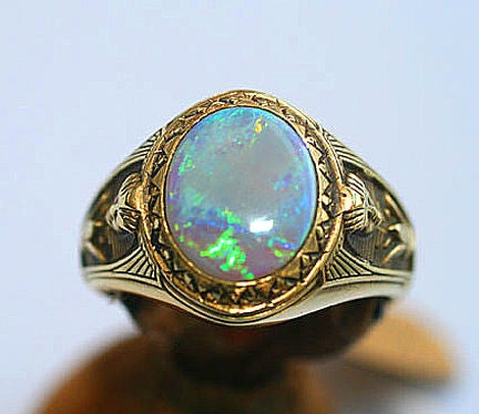 Elegant and unusual man's ring with Egyptian motifs, centering an opal. Ring size 10, can be re-sized.