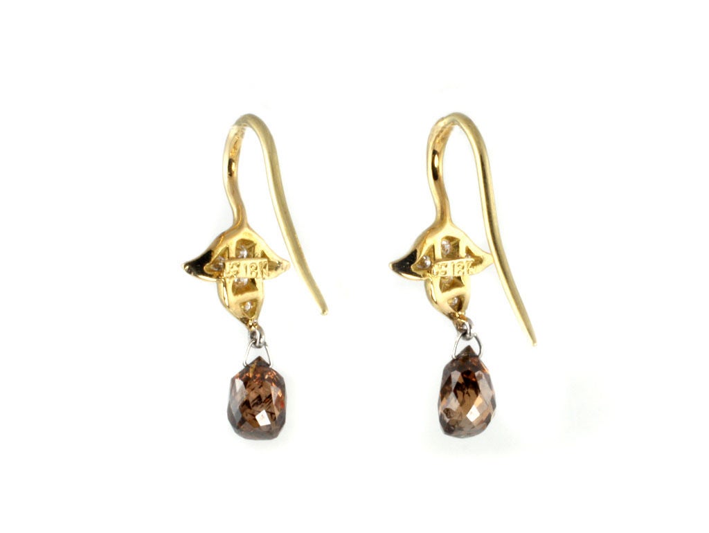 These natural color diamond briolette earrings are beautiful and delicate.  The top of the earring is a leaf motif that is used in many of our pieces.  These earrings are also available with drop stones of your choosing.  (Price will vary with stone
