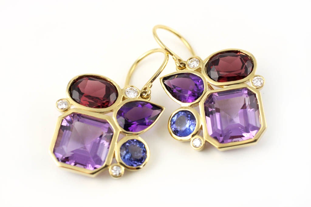 Playful and sophisticated violet colored earrings.  These earrings are inspired by the whimsical shapes and colors in a kaleidoscope. The open 18kt Gold bezel settings in these earrings allow the stones' clarity and color to shine through. 