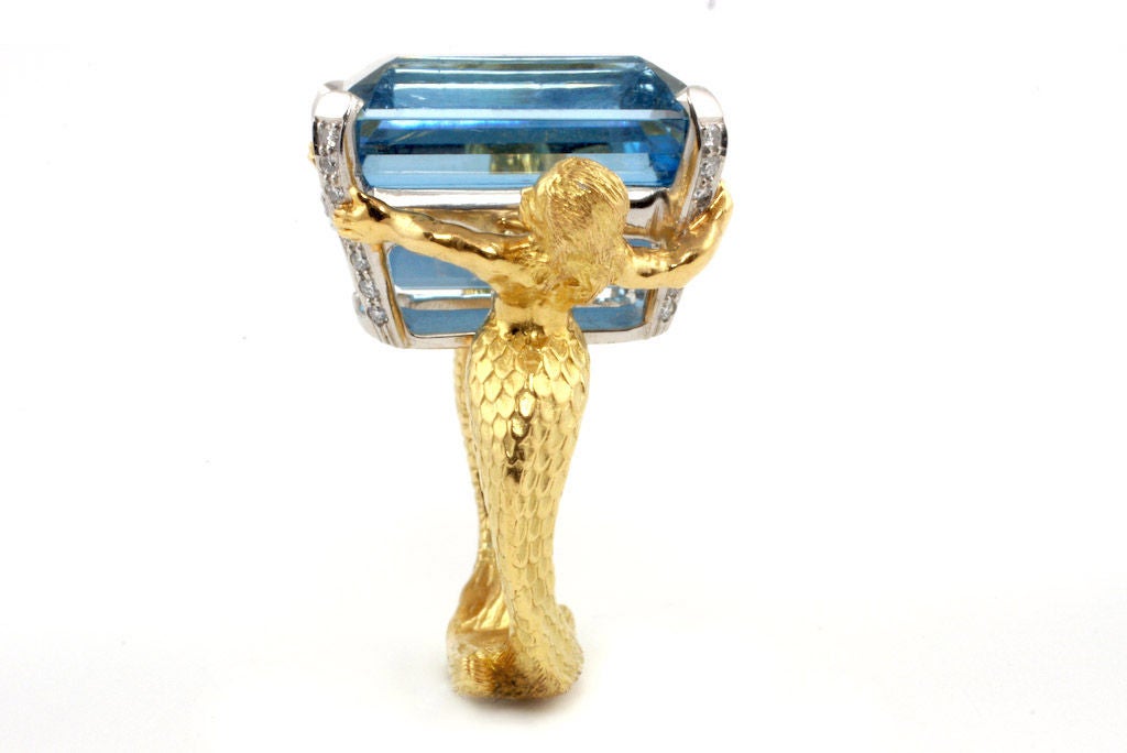 Extraordinary 18kt gold, platinum, diamond and aquamarine  mermaid and merman ring.  Beautifully hand-crafted, this expressive ring is set with an exceptional 27.87 ct. emerald cut aquamarine stone.  Designed and made in-house by Julius Cohen New