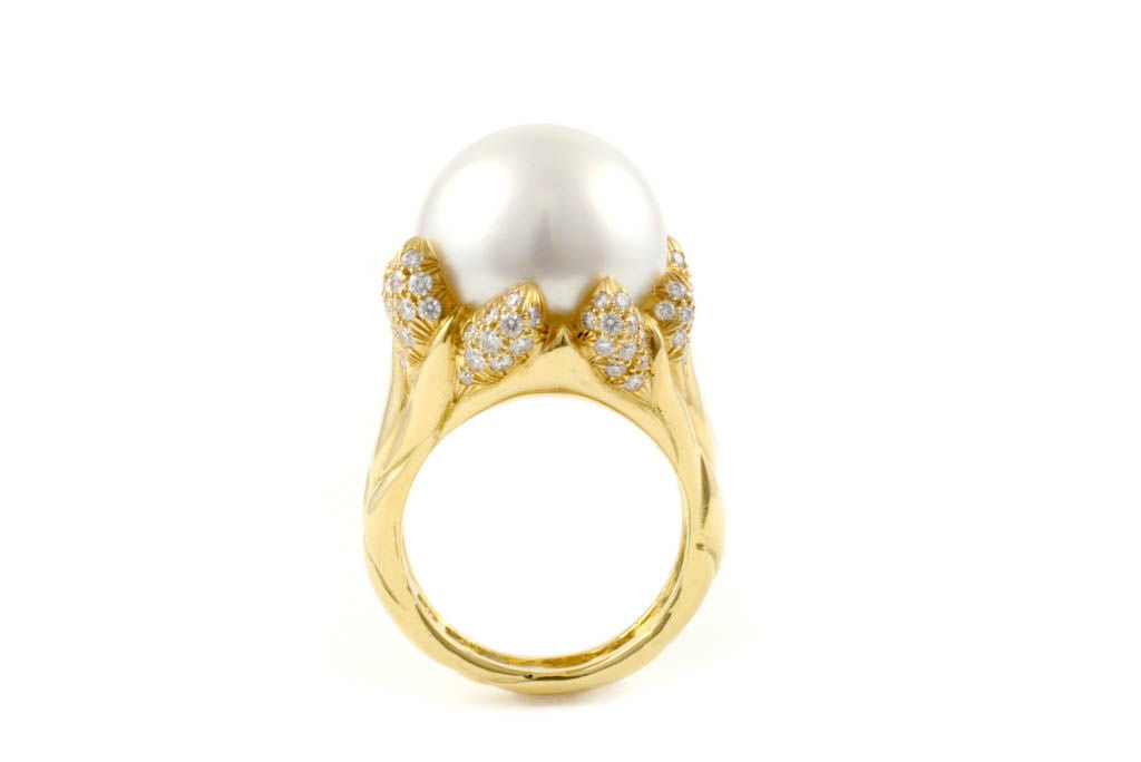 18 Kt Gold, Diamond and Pearl Flame style ring.  

The tips of the flames are done with pave diamonds.  Cultured pearl is 15.2 x 14.9 mm.  

Designed and made-house by Julius Cohen New York.