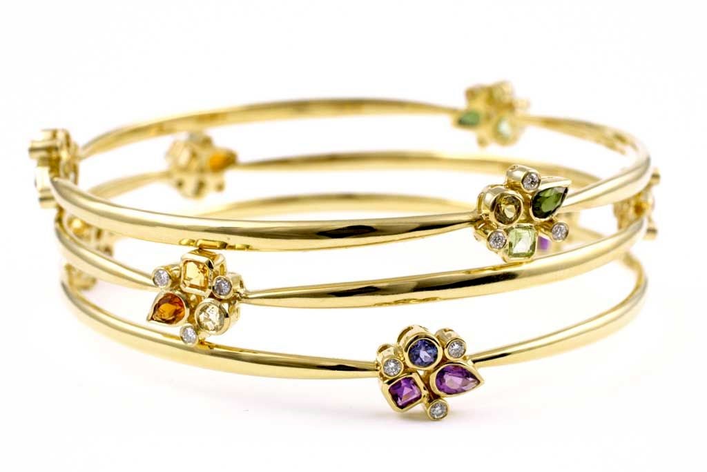 Three beautiful and playful bangles are made with 18kt gold, diamonds and various gemstones.  
Amber color bracelet contains various shades of Citrine, 
Violet color bracelet contains Amethyst and Tanzanite
Fern color bracelet contains Peridot,