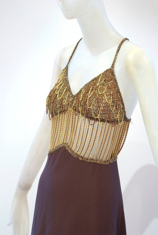 Loris Azzaro was synonymous with French jet set good-time chic in the 1970s and early 1980s. His glamorous and sexy dresses were worn by Marissa Berenson, Sophia Loren and Racquel Welch.<br />
<br />
This slinky jersey gown with a gold and bronze