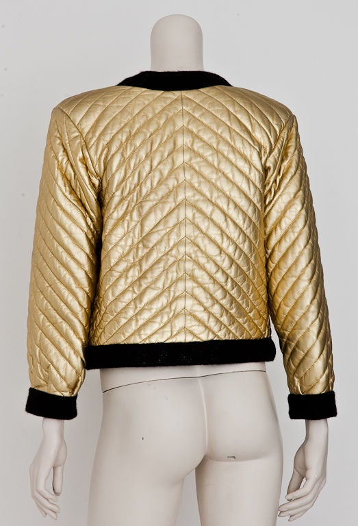 Yves St. Laurent leather quilted cropped jacket edged in a wide wool knit braid. Interior is lined in a wool jersey.