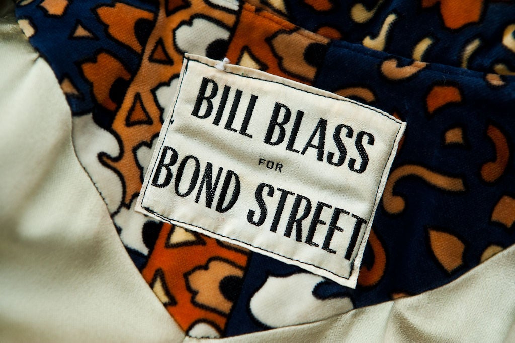 Art Nouveau Velour printed Trench style coat designed by Bill Blass for Bond Street. Dark blue ground with shades of orange,pale yellow and white.