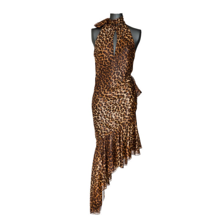 Leopard print sheer silk bias cut dress with asymetric flounce hem open back and peek-hole front. Sleeves are halter cut and neckline has wrap tie as well as side back waist. Silk is doubled.