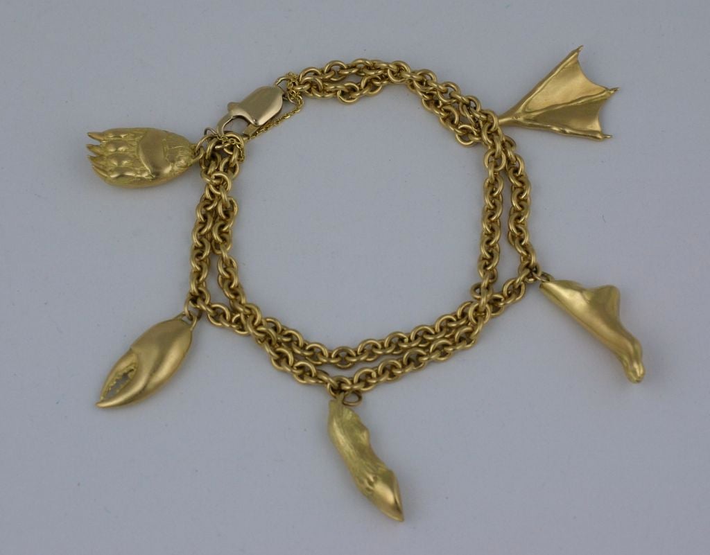 Unusual charm bracelet by Gabriella Kiss in extremely heavy 18K/14K combination.<br />
Figural charms include duck,bear,deer,human and lobster parts all beautifully and poetically sculpted in 3D.<br />
A fantastically rendered bracelet from one of