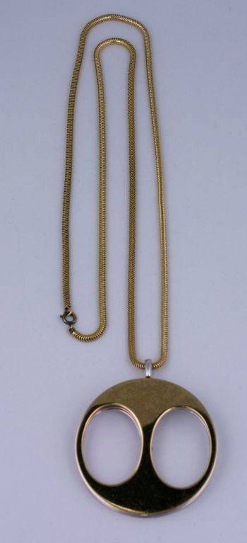 Unusual Christian Dior Pendant with rotating color wheels in gold,copper and silver plate. Made in Germany for Dior by Grosse dated 1971.<br />
2.5