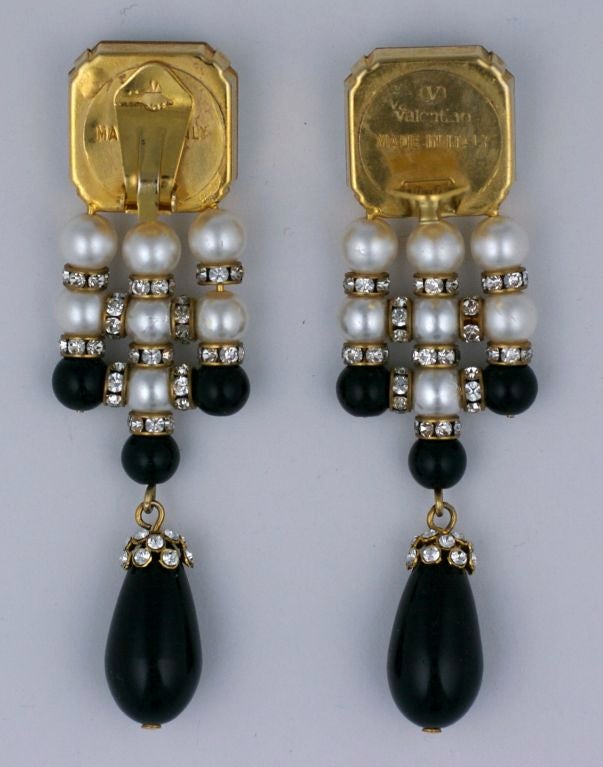 Unusual Valentino clip earrings from the 1980s are composed of a large facetted crystal and a woven basketweave of pearls, pave rondels and black glass beads. A pave cap surronds the black glass dangling drop. Extremely unusual construction.<br