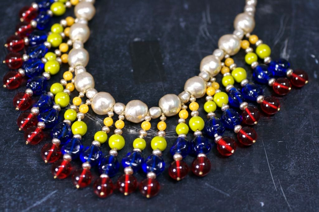 Rare, collectible Miriam Haskell bib necklace of signature baroque pearls, sapphire, ruby, chartreuse and mustard  Gripoix Glass poured glass beads from the 1940's. Exceptional color combination.<br />
Length 18.5