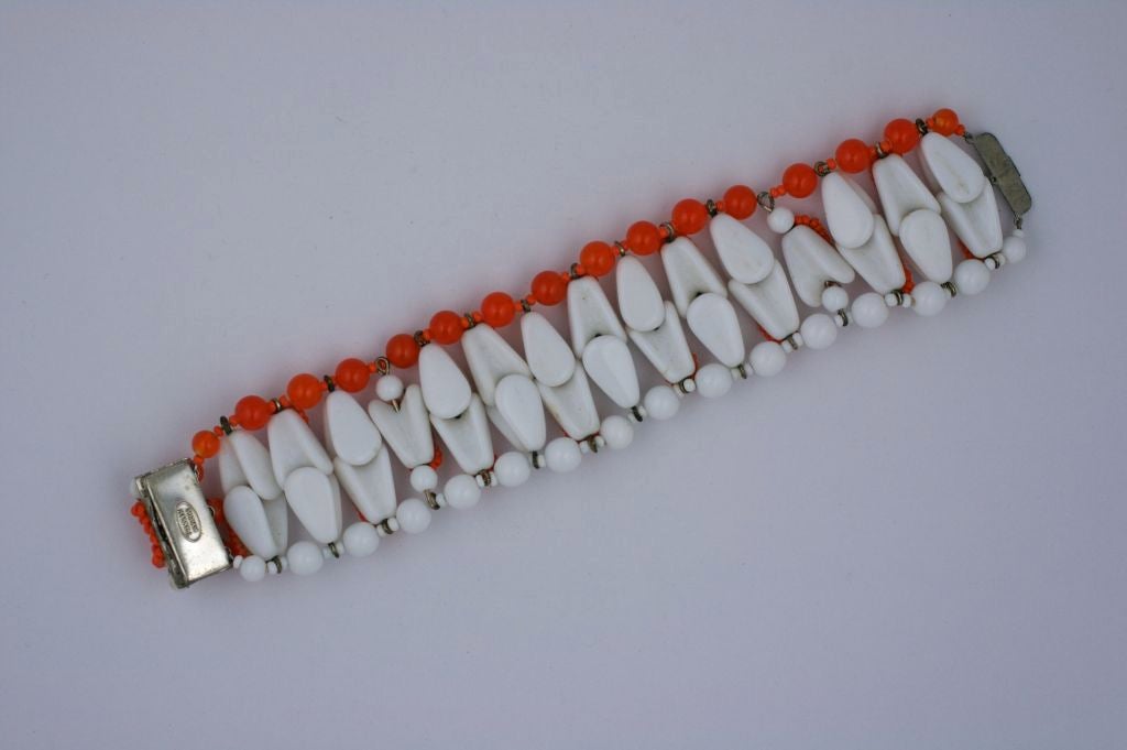 Miriam Haskell signed bracelet composed of milk glass, tangerine and yellow seed beads. Silvered box clasp.<br />
Excellent condition<br />
Signed Miriam Haskell<br />
Length: 8". Width 1 5/8".