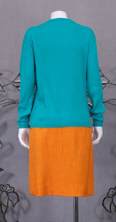 Courreges rib knit cardigan in soft cotton/acrylic blend. 2 rib knit pockets with logo attached.<br />
Sleeve length: 21.5