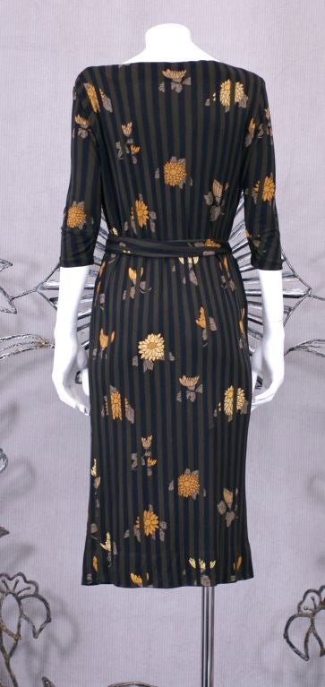 American born designer Ken Scott along with Emilio Pucci epitomized the modernity of Italian fashion in the 1960's and 70's. An easy pull on silk jersey print of Japanesque flowers within a graphic brown/black stripe. Lined self belt with a bateau