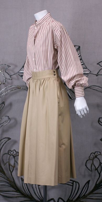 Simple and perfectly cut YSL Khaki cotton twill skirt with trapunto waist and snap closures. Full circle skirt is gathered at waist.   Side pockets in seams. 1970's France. Excellent condition. 
Vintage size: 40<br />
Waist 26