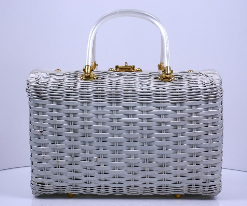 Fun beach theme bag by Atlas of Hollywood Fla.circa 1960.<br />
Coated white wicker with pearlized bakelite frame and handle. Front has 