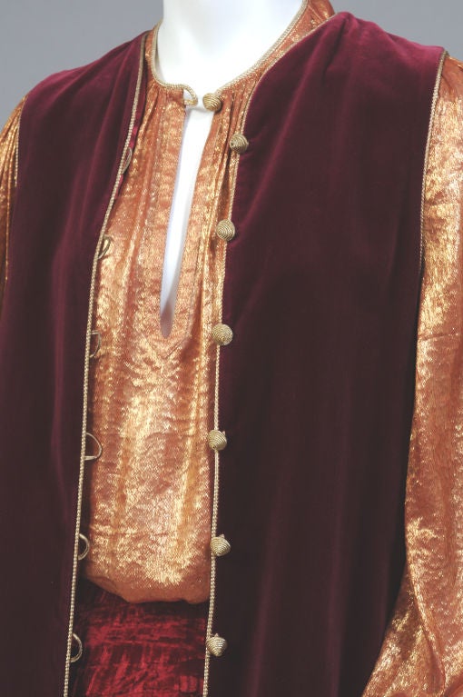 Burgundy velvet vest, pleated velvet skirt and a gold lame blouse from the Russian collection of Yves St Laurent