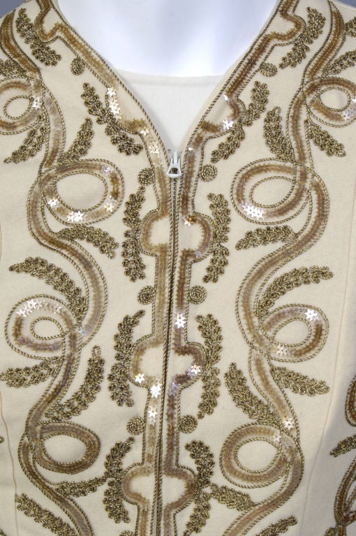 A late 1930's evening jacket is embellished with meandering ribbon like bands of star shaped sequins and gold braid. The perfect little accessory to dress up any outfit, think of it as piece of jewelry.<br />
<br />
The lightweight butter cream