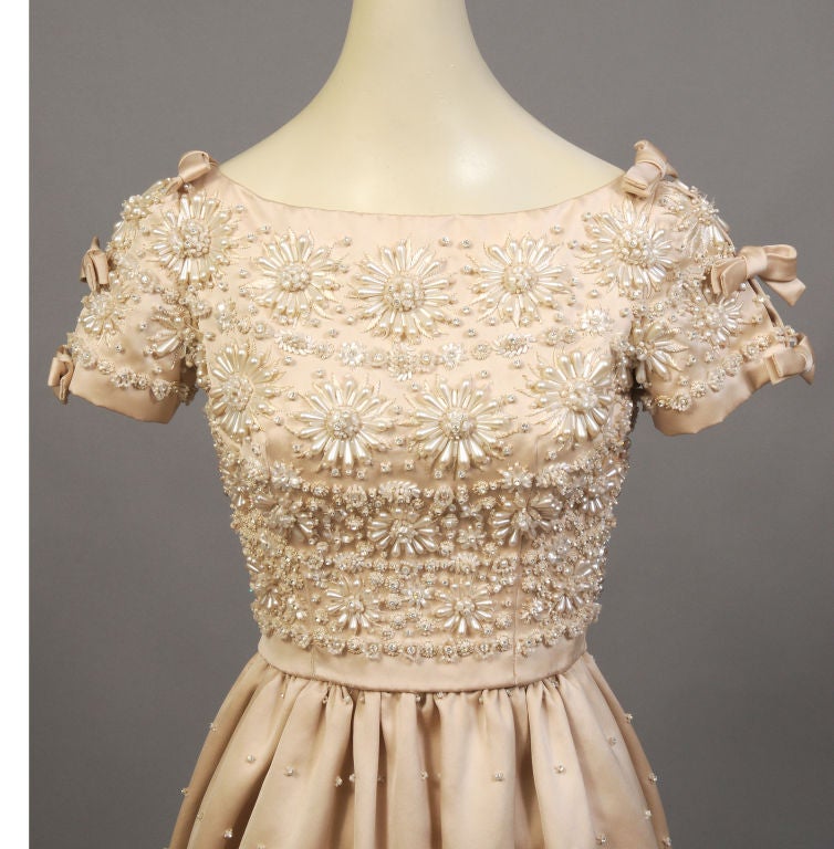 Fantastic cocktail or short evening dress designed by Yves St Laurent during his brief tenure at Christian Dior in the late 1950's. The elaborate beadwork is undoubtedly by Lesage, Paris,  This dress is from the estate of a French Countess.