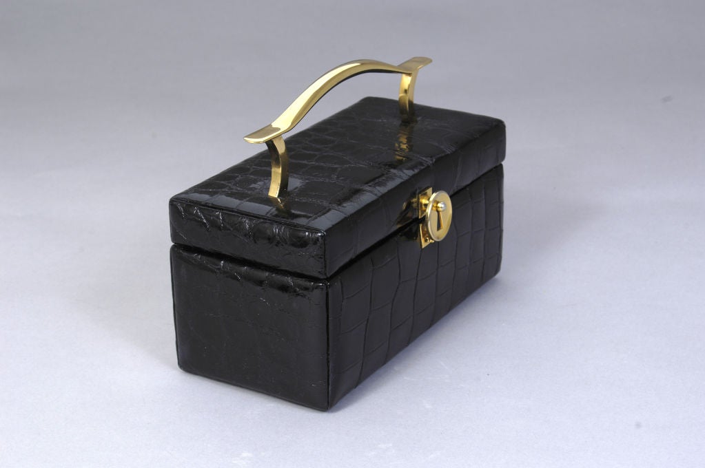 This is a great vintage alligator box bag from the 1950's. The lustrous black skins are the perfect match for the modernist hardware.<br />
<br />
Koret, an American manufacturer was known for their high quality and innovative designs. This bag is